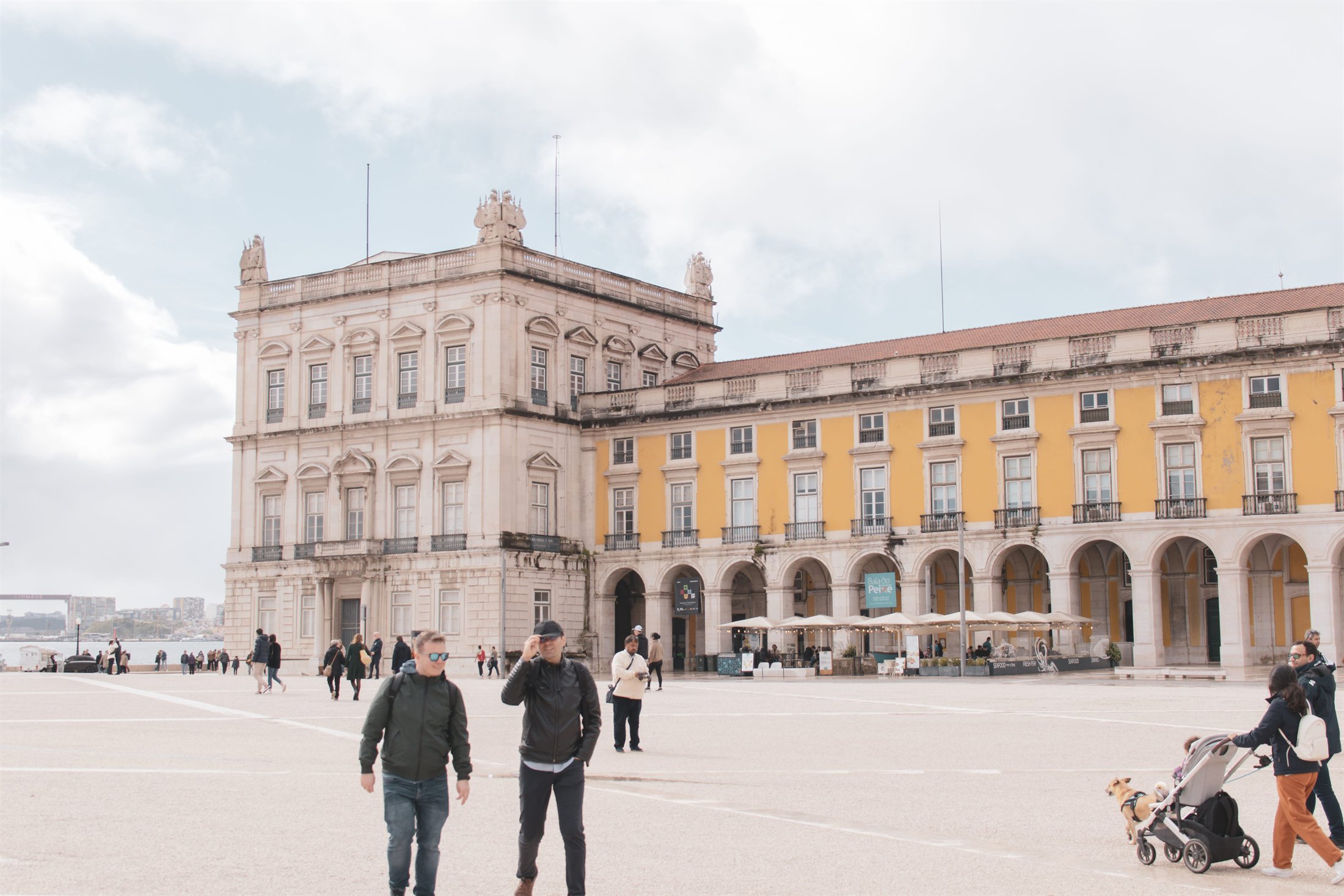 Travelers crossing Lisbon's Commerce Square on a first city day