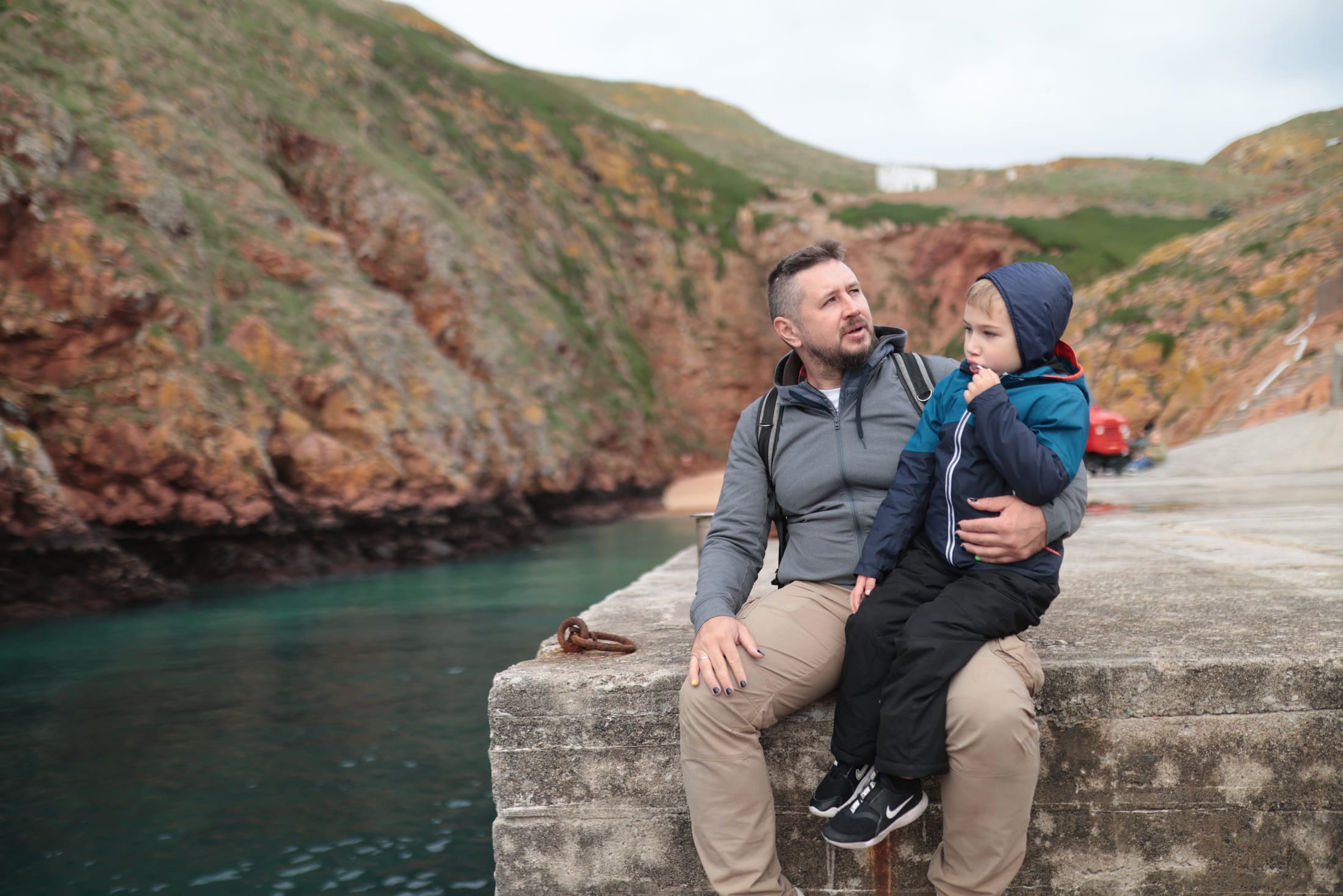 Family resting by the Portuguese coast during a school holiday trip