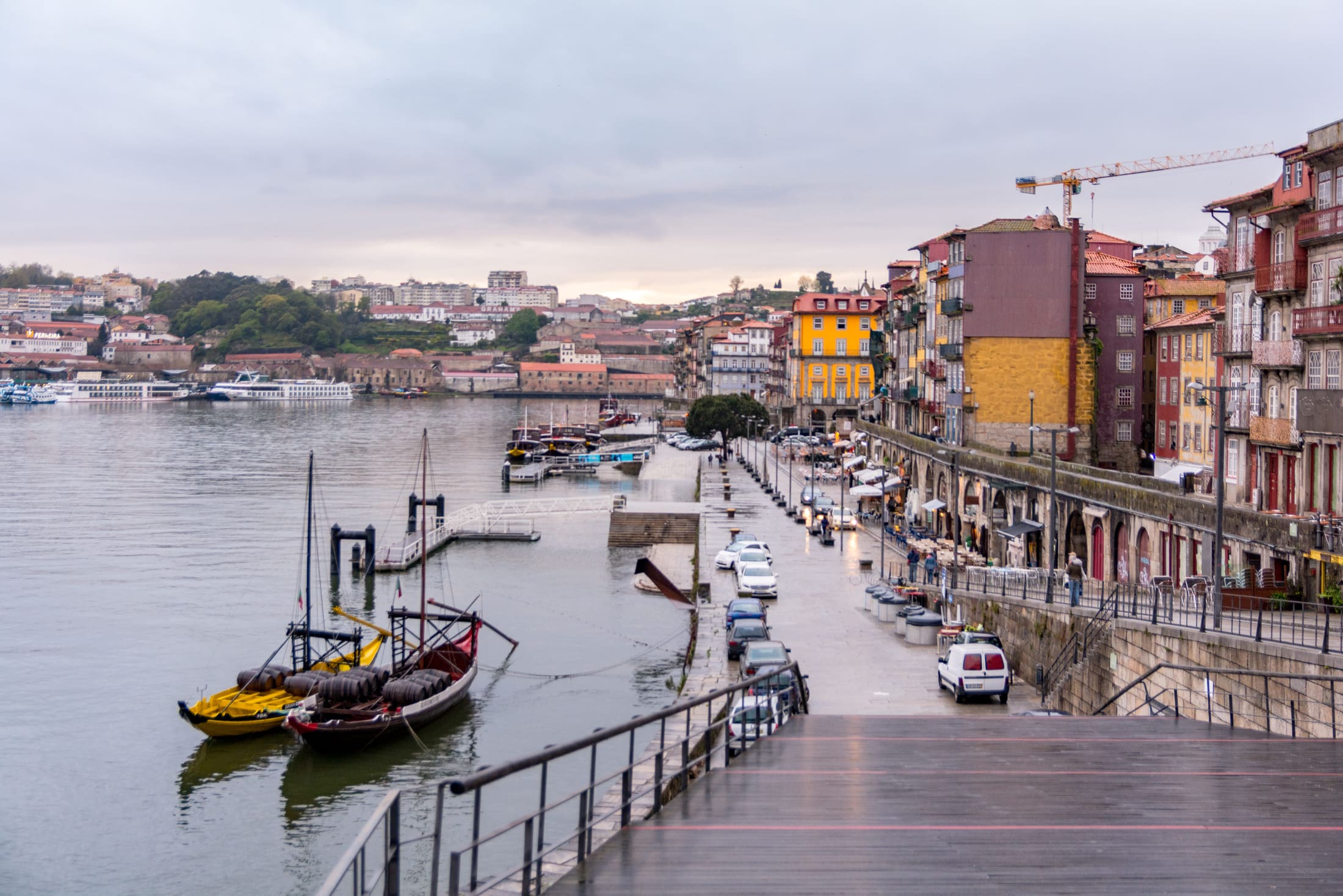 Rainy Porto riverfront with boats on the Douro
