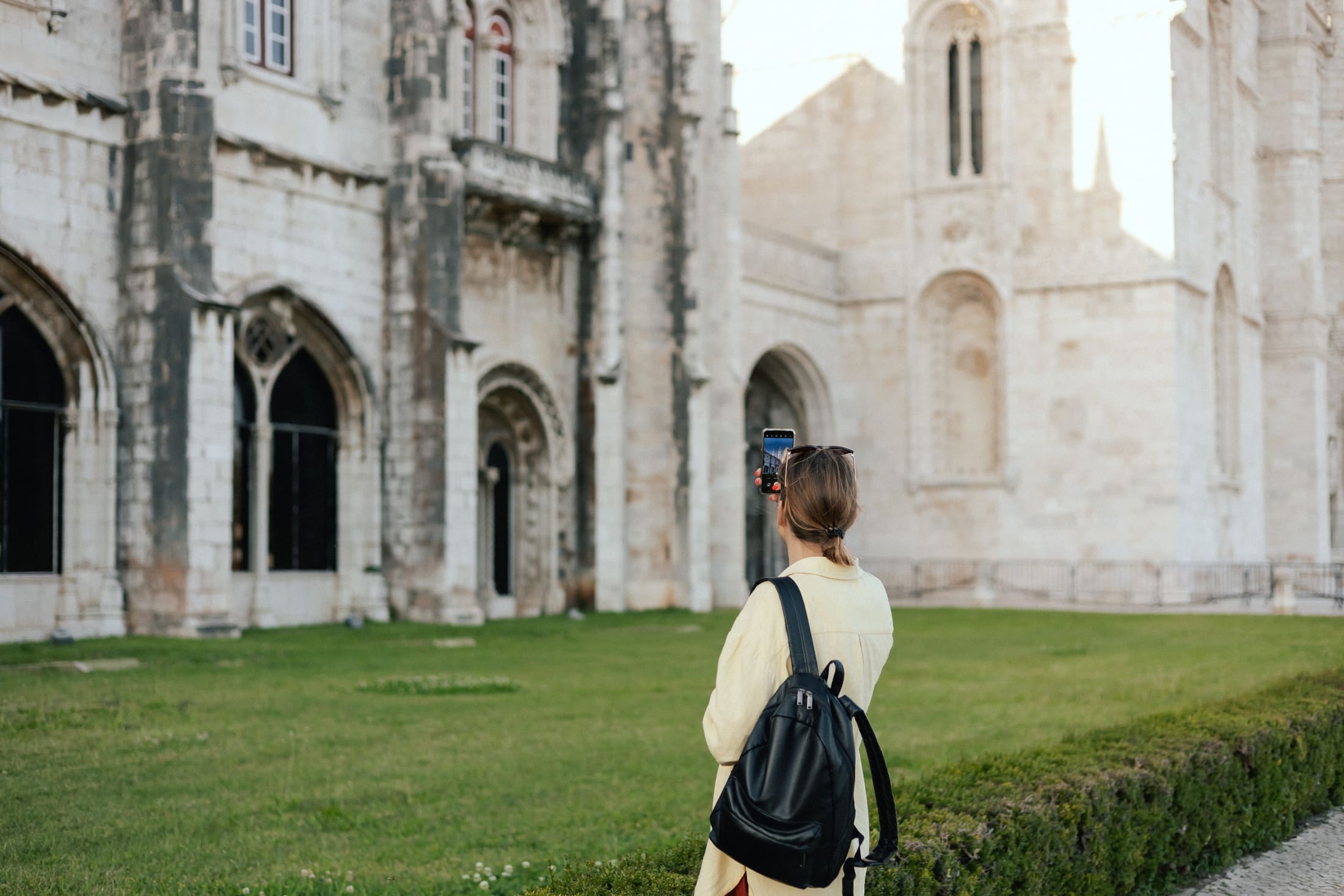 Traveler dressed respectfully for a historic monastery visit in Portugal