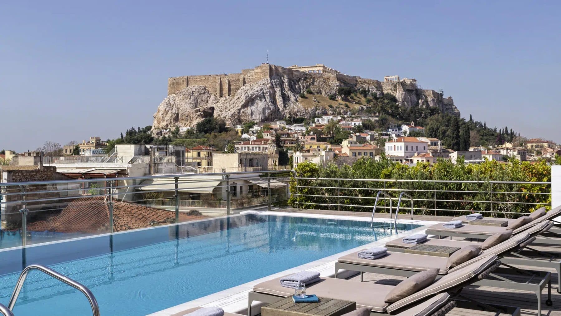 Outdoor swimming pool, loungers and Acropolis backdrop at Electra Palace Athens.