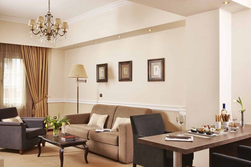 Sofa, armchairs and dining table in an AVA Executive Suite living room.