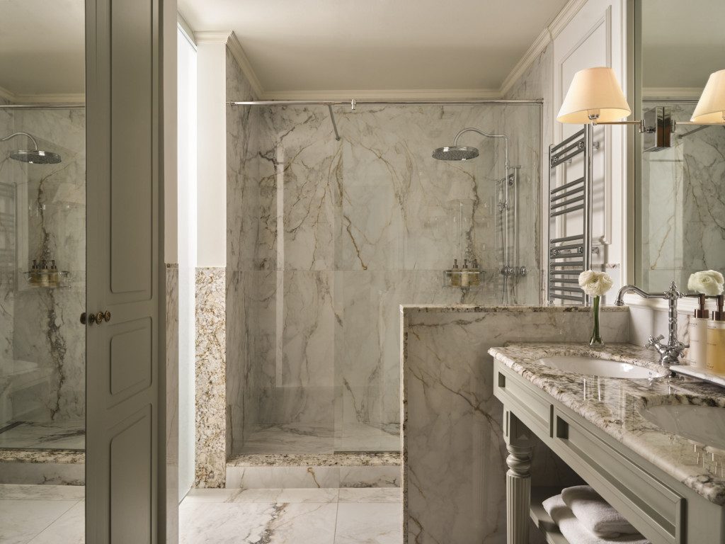 Marble shower bathroom shown on El Palace’s family-room page.