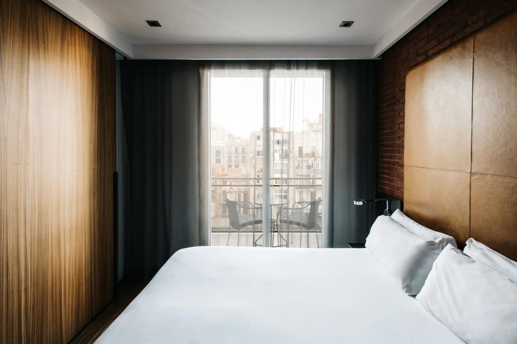 Outdoor seating visible beyond a Double Executive bedroom at Granados83.