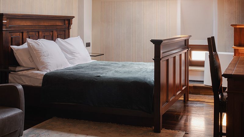 Double Room at Hotel Copernicus with a dark wood bed and desk.