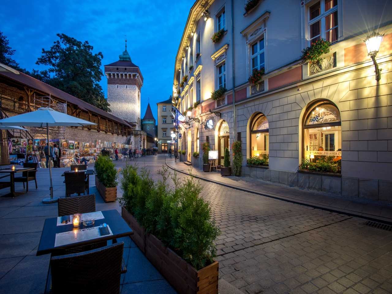 Hotel Polski façade and the adjoining Old Town street at dusk.