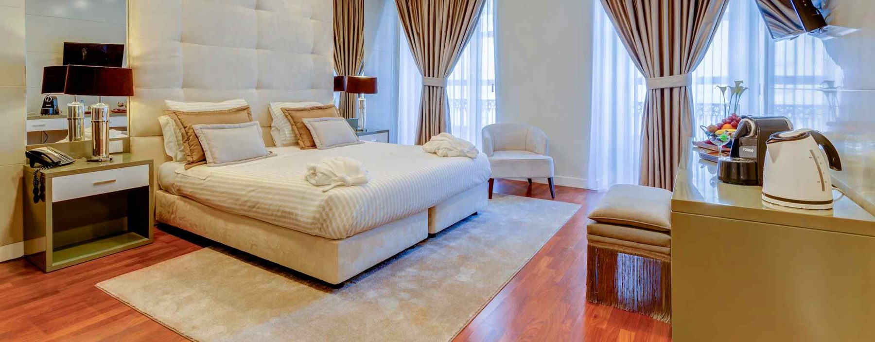 Double Superior Chiado View bedroom with tall windows and cream furnishings at Hotel Borges Chiado.