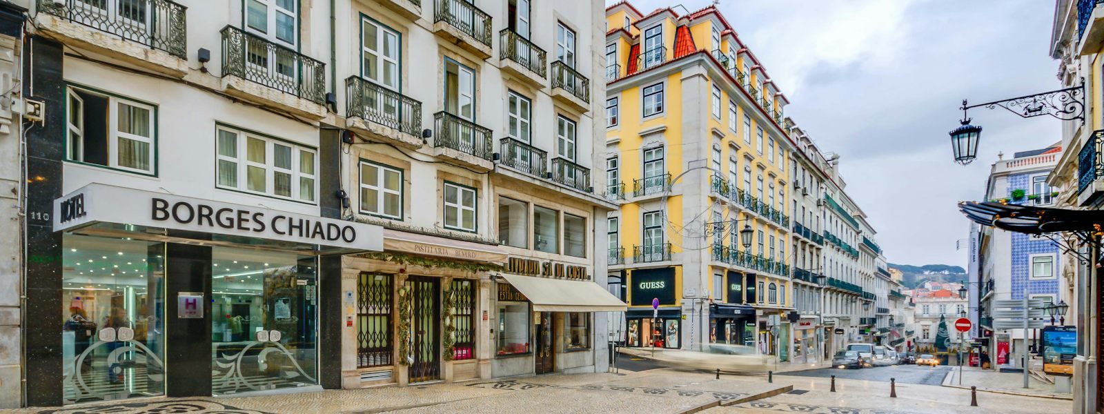 Borges Chiado entrance beside shops on the sloping Rua Garrett.