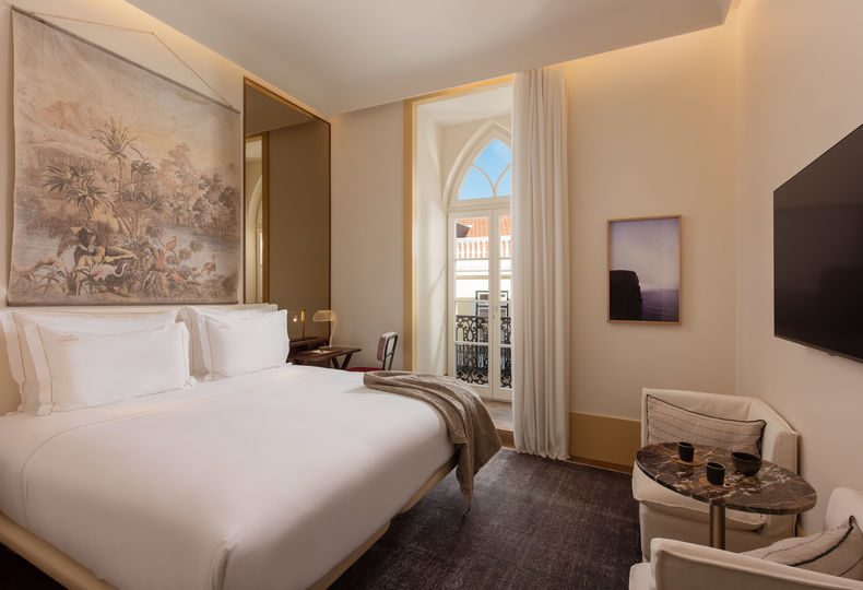 Ivens Balcony bedroom with an illustrated wall panel and tall glazed balcony door.