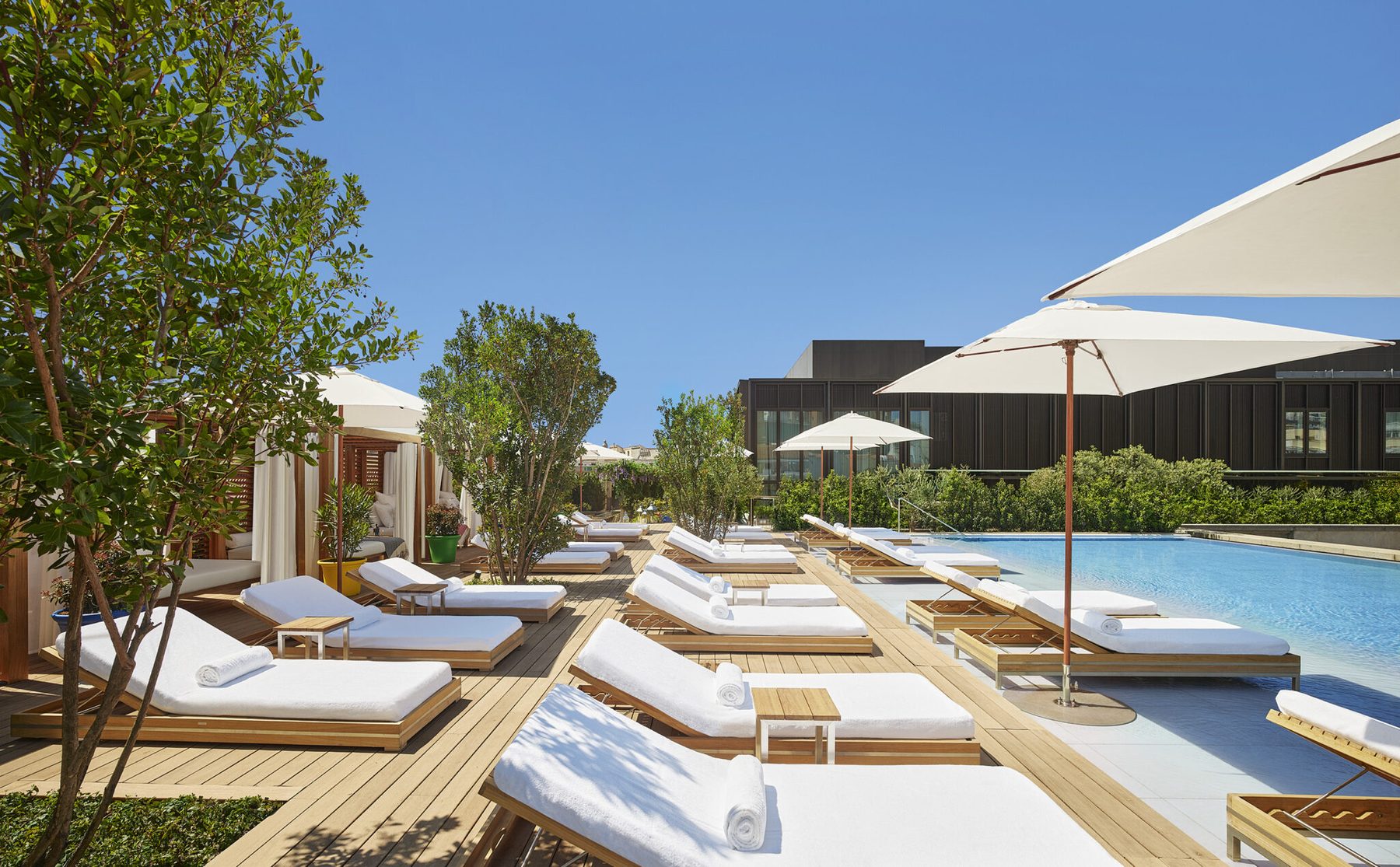 Outdoor rooftop pool and loungers at The Madrid EDITION.