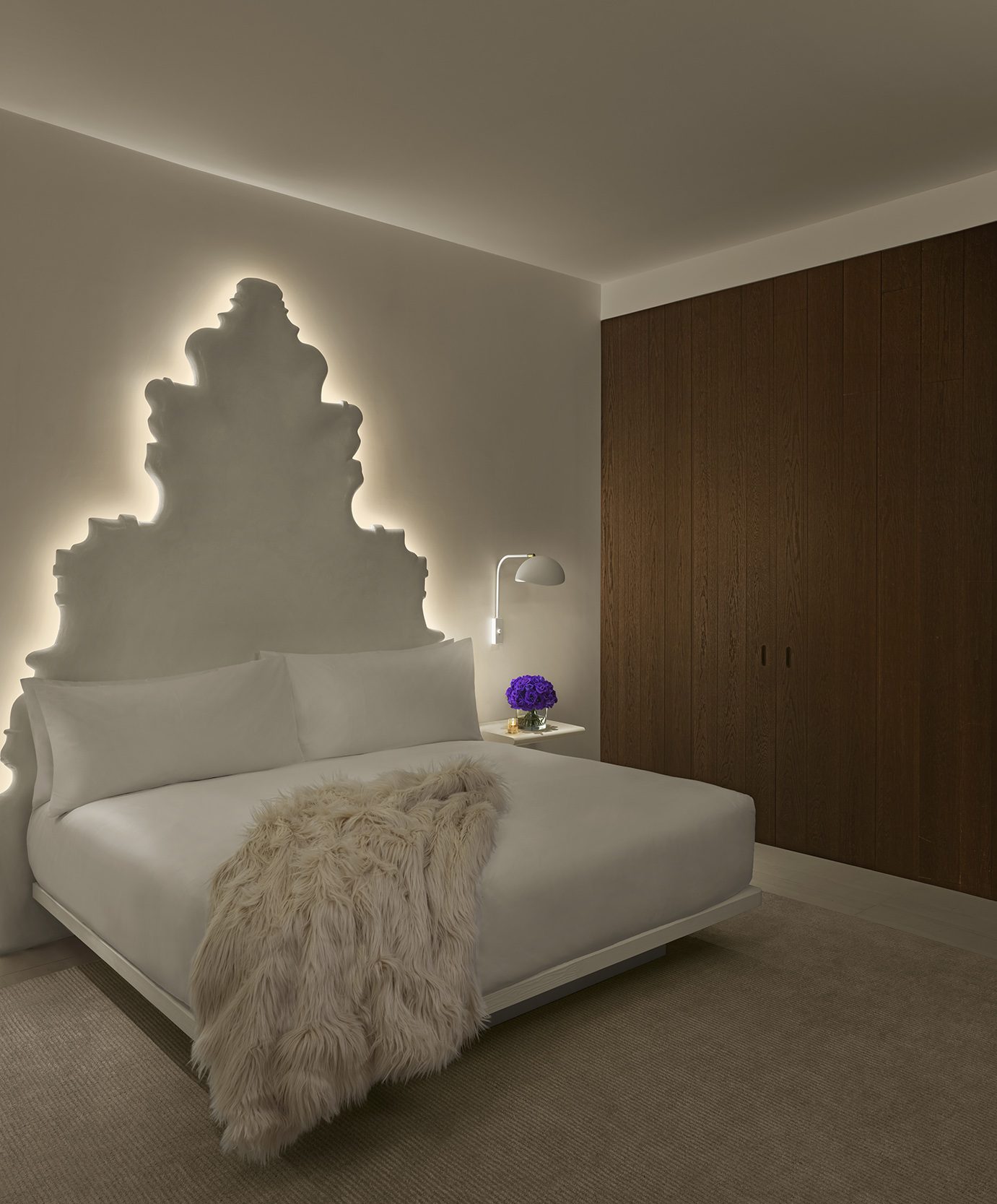 Superior King bedroom with illuminated sculptural headboard at The Madrid EDITION.