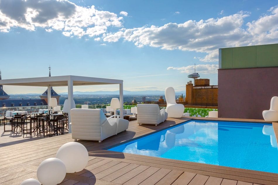 Small rooftop swimming pool beside the deck and seating at Exe Moncloa.