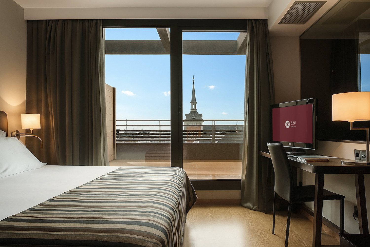 Exe Moncloa Superior bedroom opening onto its private terrace.