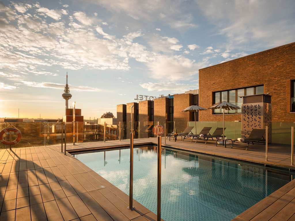 Rooftop pool and deck at sunset at Novotel Madrid Center.