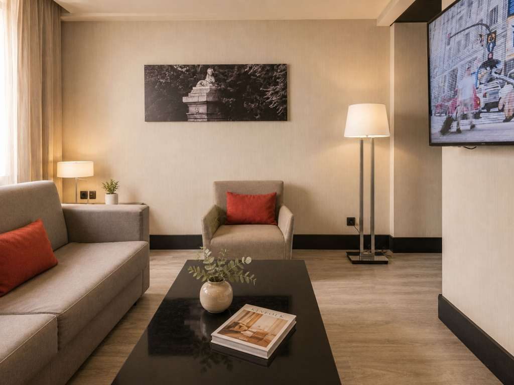 Grey sofa and armchair in Novotel Madrid Center’s Executive room lounge.