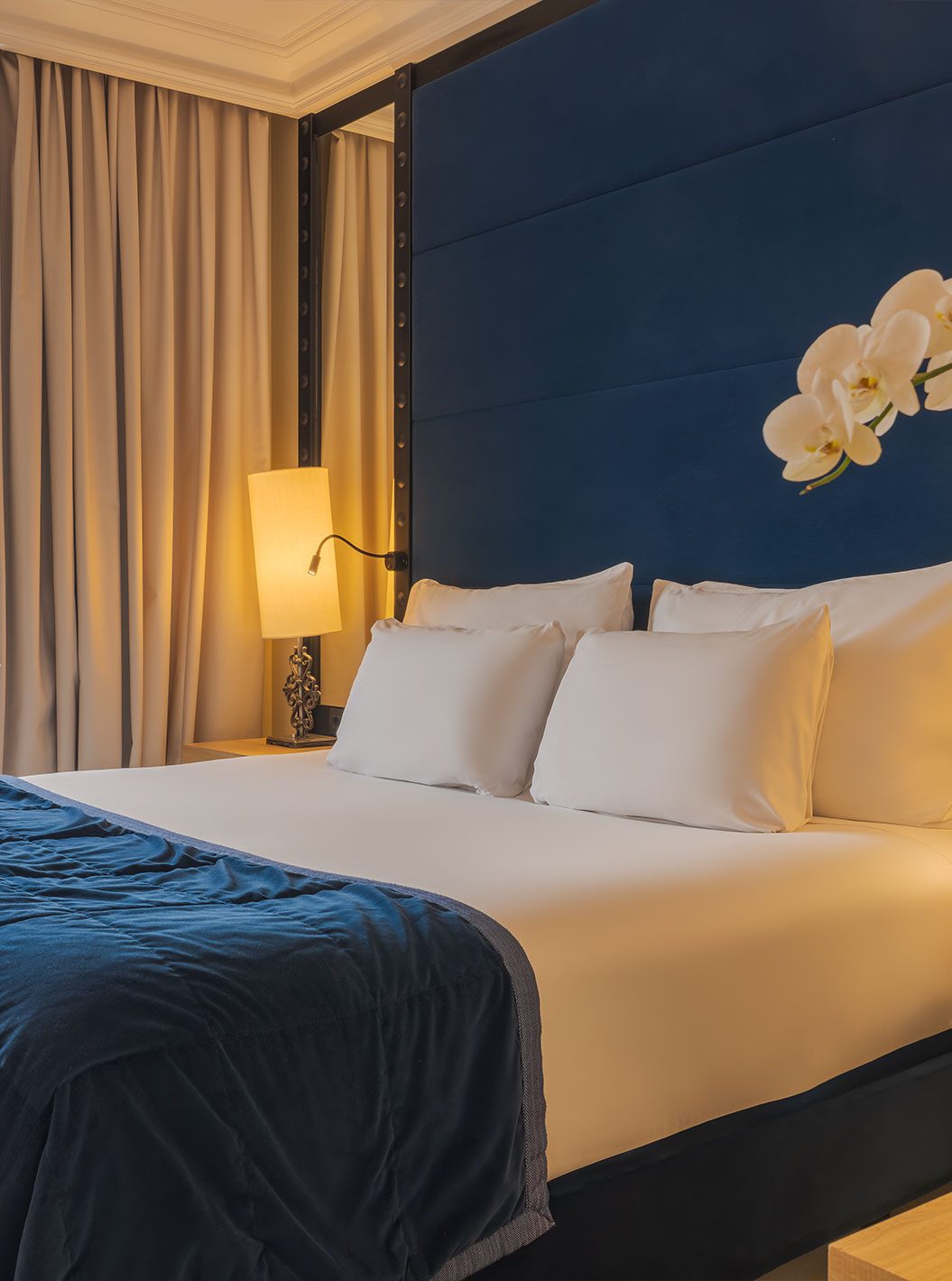 Blue headboard and bedding in a Plaza Mayor Superior room at Pestana Collection Plaza Mayor.