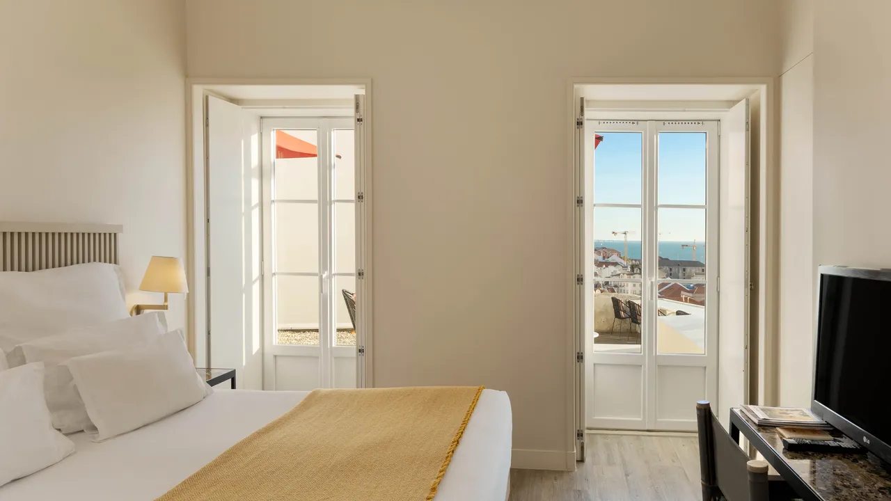 Terrace Room bedroom and open door to its private deck at Memmo Alfama