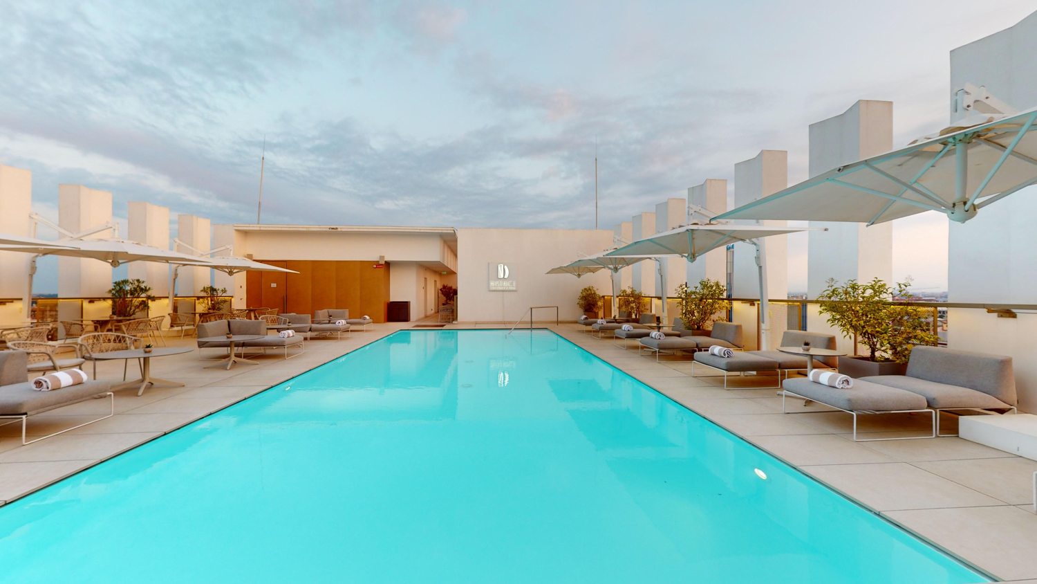 Rooftop swimming pool and loungers at NH Collection Milano CityLife