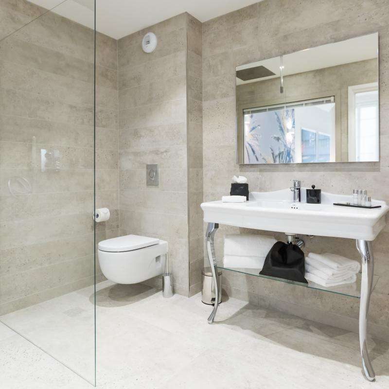 Glass shower enclosure and basin in the tiled Junior Suite bathroom at Palais Saleya