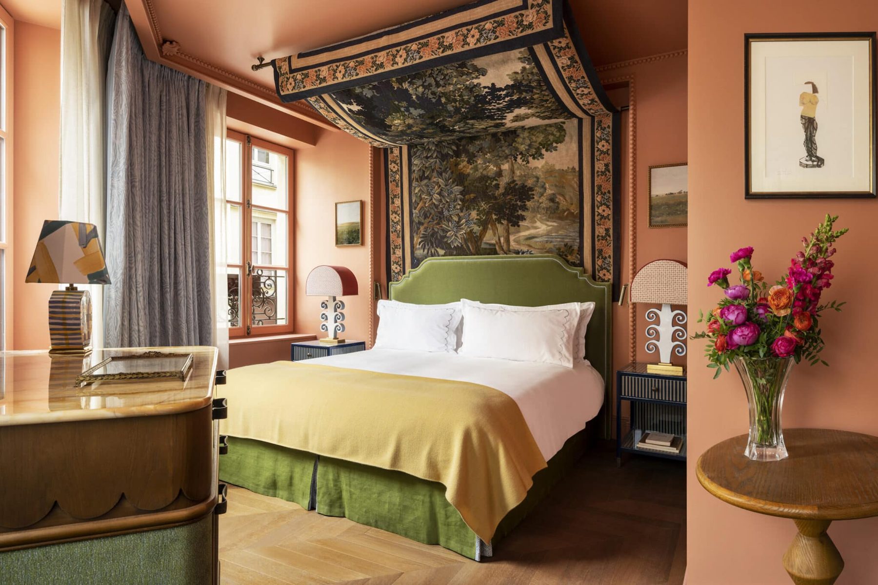 Deluxe bedroom with a tapestry canopy and green headboard at Le Grand Mazarin.