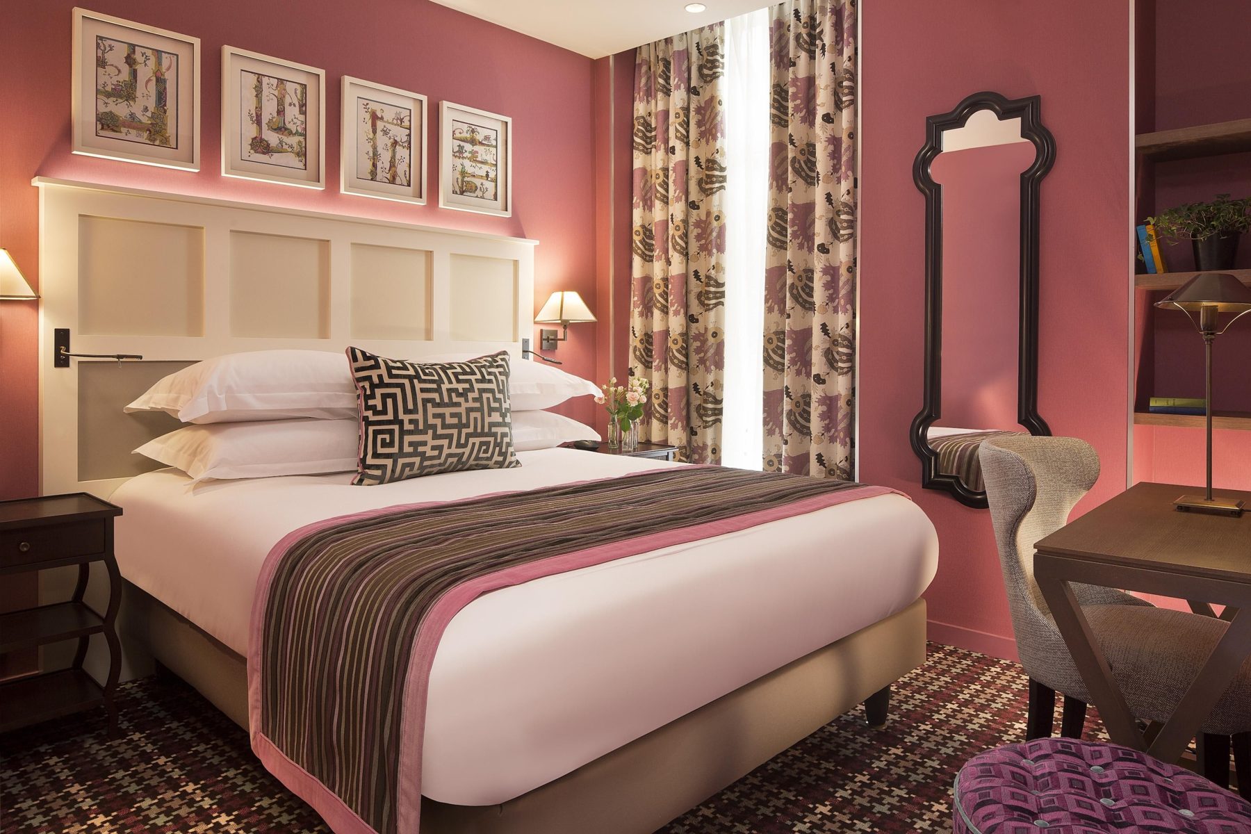 Pink bedroom with a white panelled headboard at Les Tournelles.