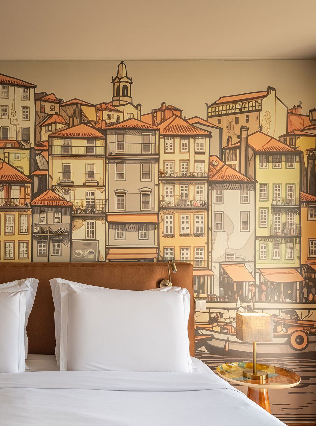 Bed and illustrated Porto streetscape behind the headboard at Pestana Vintage.