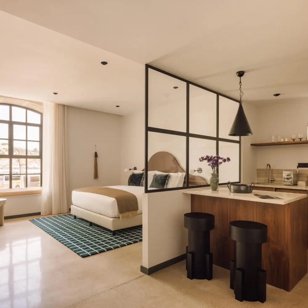 Kitchen island, stools, glass partition and low seating in a Rebello studio.