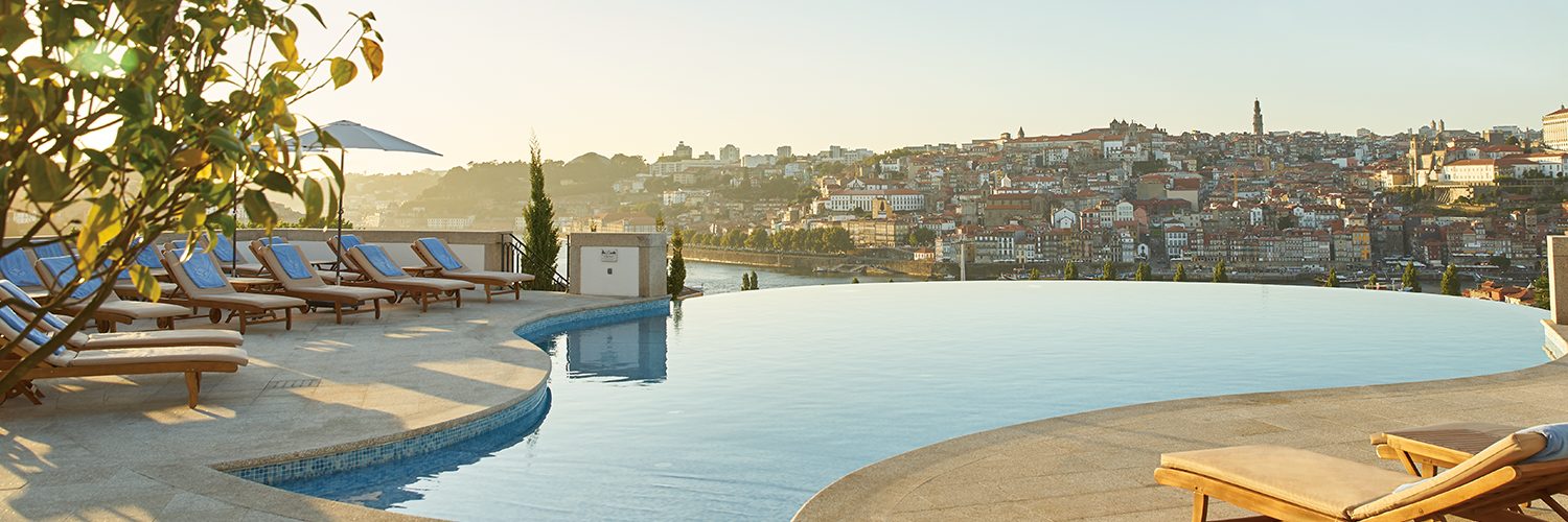 Curved outdoor infinity pool and loungers above Porto at The Yeatman.
