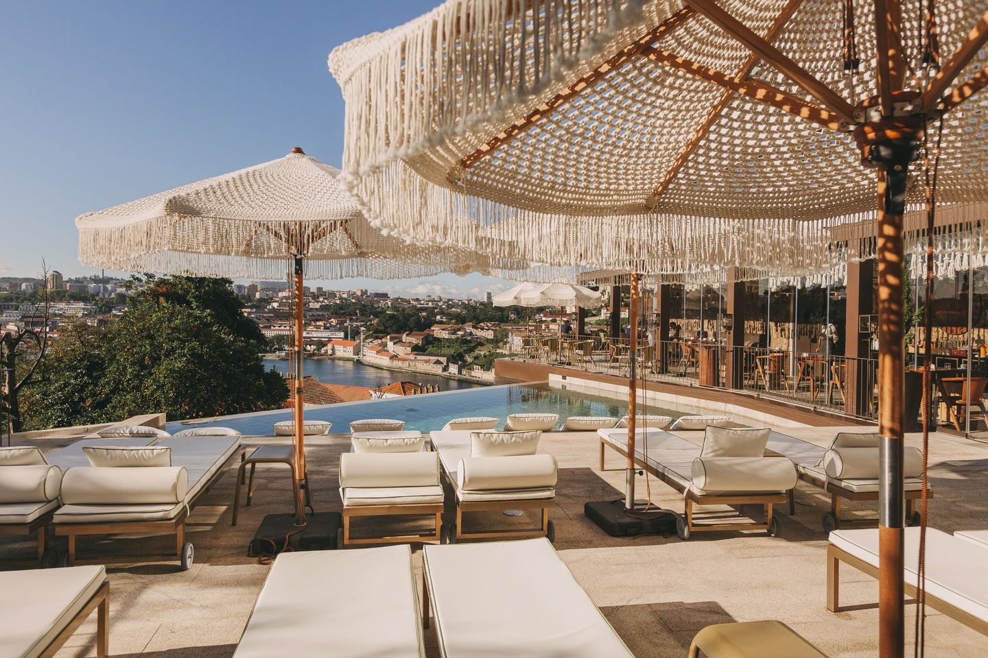 Pool edge, loungers and fringed parasols overlooking the river at Torel Avantgarde.