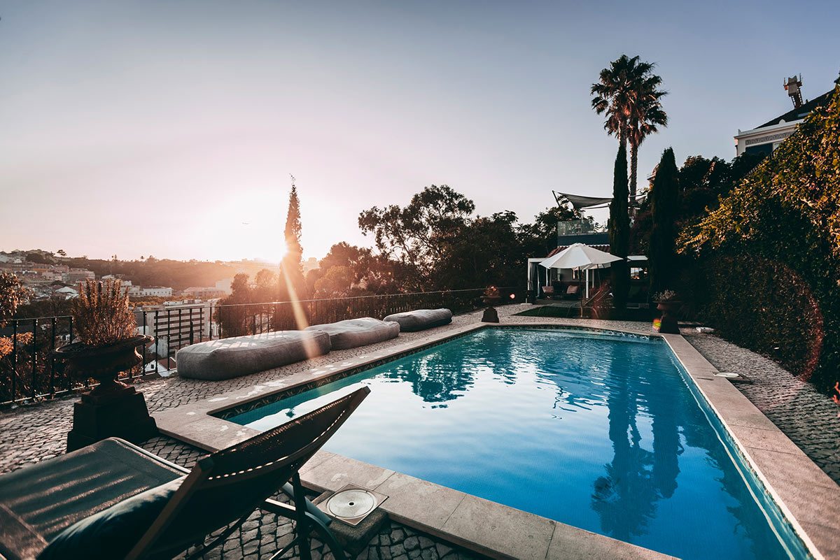 Outdoor pool at sunset at Torel Palace Lisbon