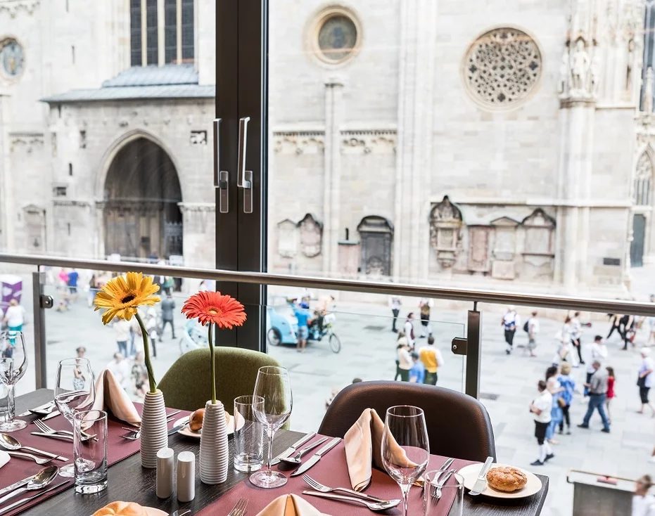 Set café table beside a window overlooking St Stephen’s Cathedral and the square.