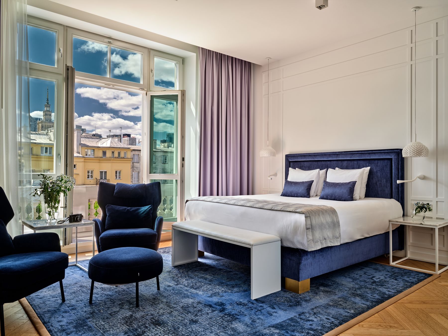 Blue bed and seating in the Hotel Indigo Warsaw Premium Queen gallery