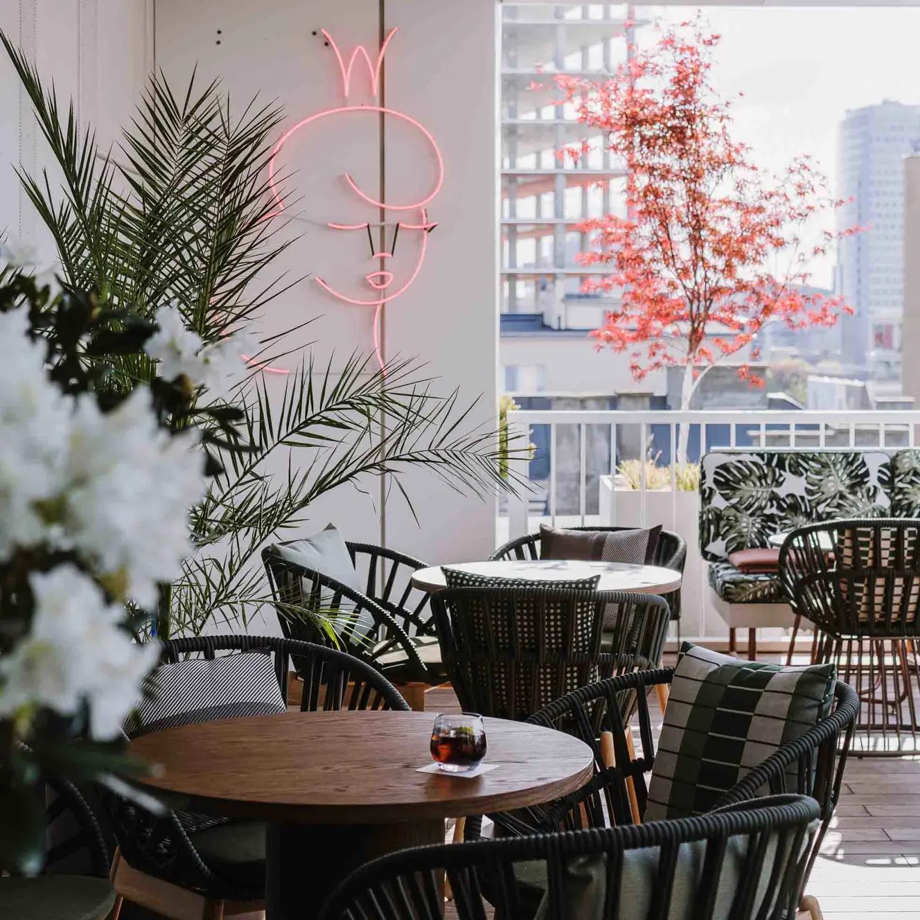Tables and planting at Loreta at PURO Warsaw Centrum