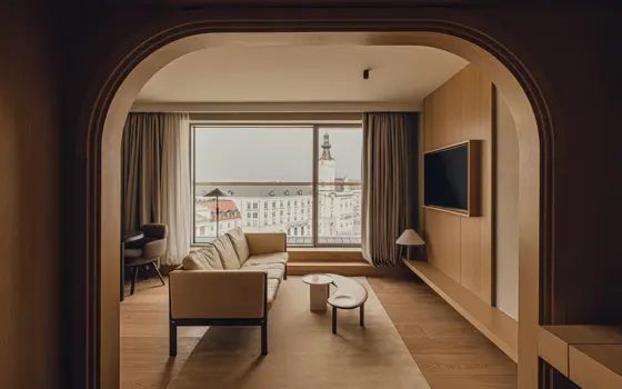 Living area through an arched opening in a PURO Warsaw Old Town Executive Suite