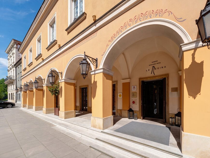 Arched entrance and ochre facade at Mamaison Le Regina Warsaw