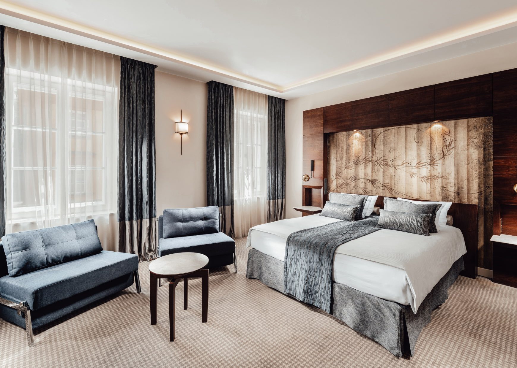 Double bed and upholstered seating in Le Regina’s Family Room