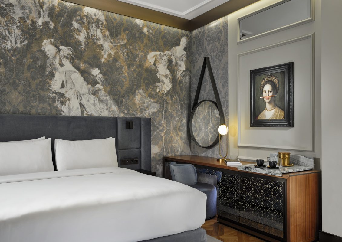 Capriccio bedroom with a patterned feature wall at Hotel Verte