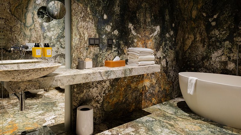 Veined stone and freestanding bath in Hotel Warszawa’s Junior Suite gallery